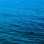 a boat floating on top of a large body of water